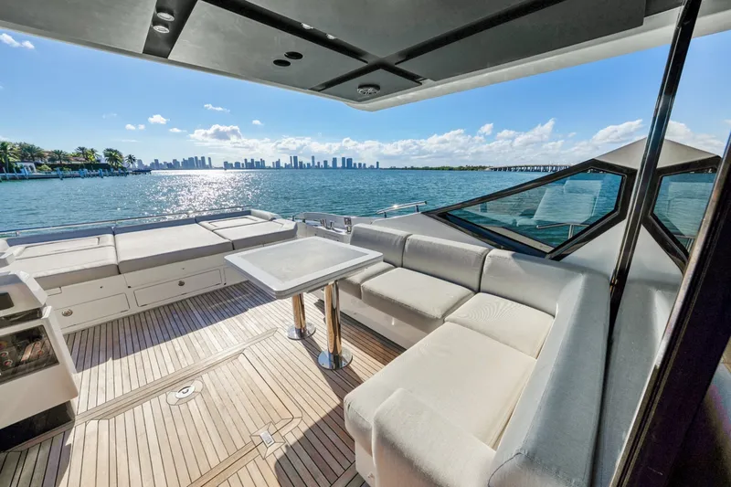 Slide: The Image of Luxurious 2018 Azimut S7 yacht deck with seating, overlooking a scenic waterfront city skyline. - 21