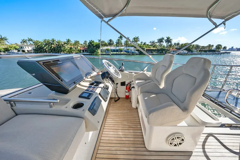 Slide: The Image of Luxurious 2018 Azimut S7 yacht helm with plush seating and scenic waterfront view. - 37