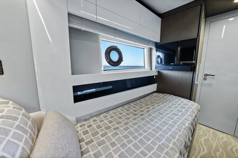 Slide: The Image of Luxurious interior of 2018 Azimut S7 yacht cabin with modern design and window view. - 2