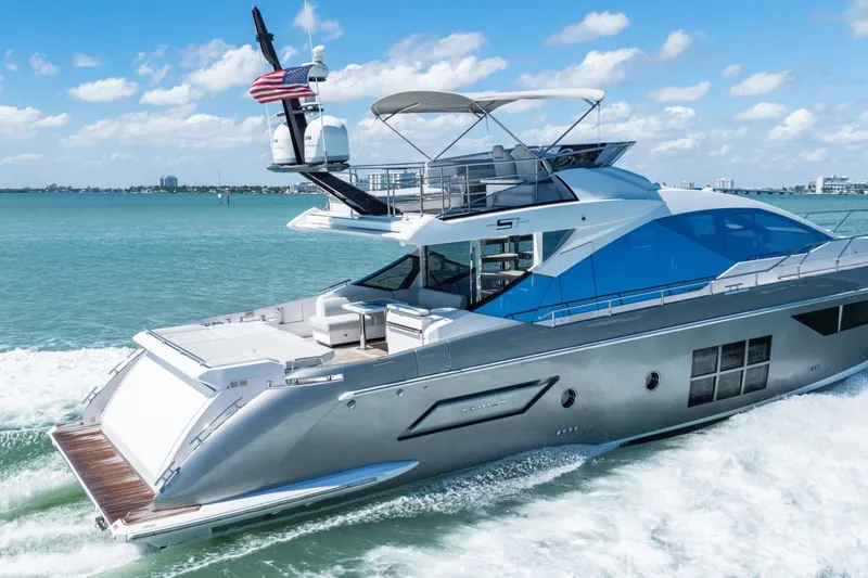 Slide: The Image of Luxurious 2018 Azimut S7 yacht cruising on clear blue waters under a sunny sky. - 17