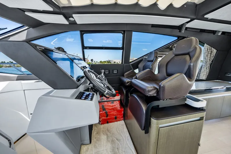 Slide: The Image of Interior of 2018 Azimut S7 yacht cockpit with modern steering and seating. - 26