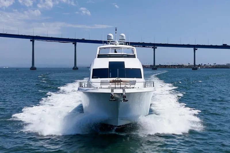 Slide: The Image of 2006 Lazzara 84 Flybridge yacht cruising under a bridge on a sunny day. - 18