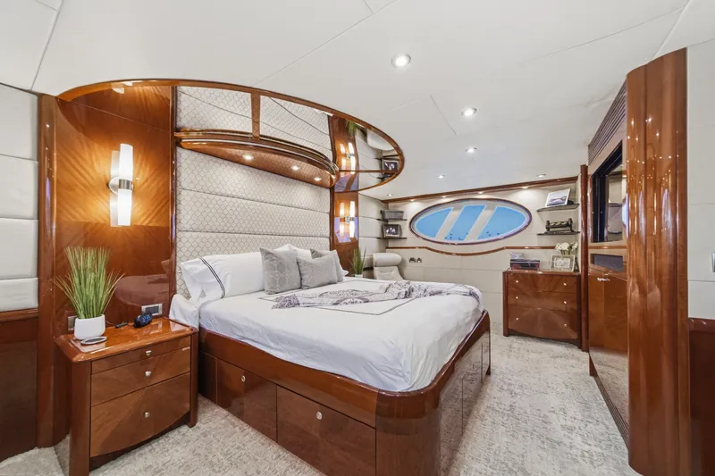 Slide: The Image of Luxurious bedroom interior on 2006 Lazzara 84 Flybridge yacht, featuring elegant wood finishes. - 83