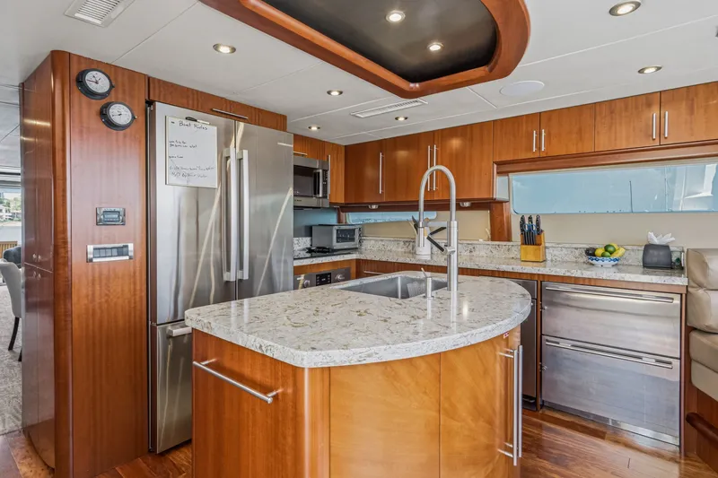 Slide: The Image of Luxurious kitchen interior of 2006 Lazzara 84 Flybridge yacht with modern appliances and wood cabinetry. - 50