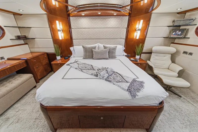 Slide: The Image of Luxurious bedroom interior of 2006 Lazzara 84 Flybridge yacht with elegant furnishings. - 88