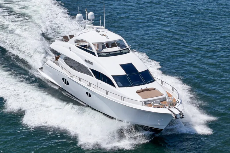 Slide: The Image of Luxury 2006 Lazzara 84 Flybridge yacht cruising on open water. - 4