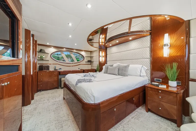 Slide: The Image of Luxurious bedroom interior of 2006 Lazzara 84 Flybridge yacht with elegant wood finishes. - 86