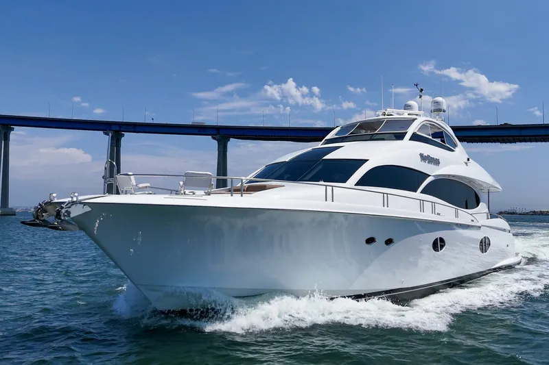 Slide: The Image of 2006 Lazzara 84 Flybridge yacht cruising under a bridge on a sunny day. - 10
