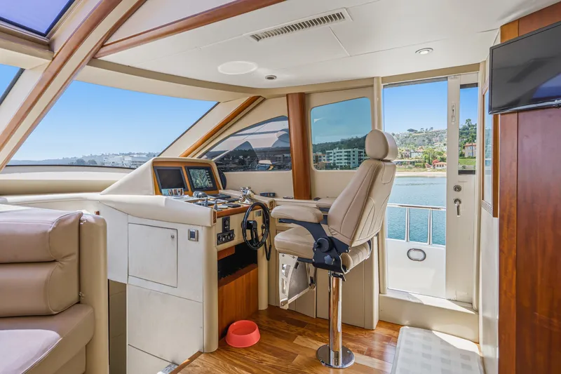 Slide: The Image of Luxurious helm of 2006 Lazzara 84 Flybridge yacht with panoramic views. - 59