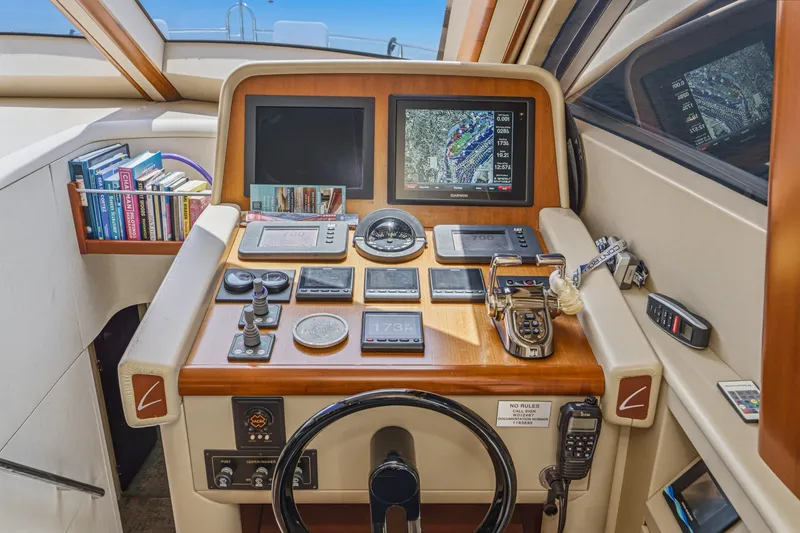 Slide: The Image of Helm of 2006 Lazzara 84 Flybridge yacht with navigation screens and controls. - 60