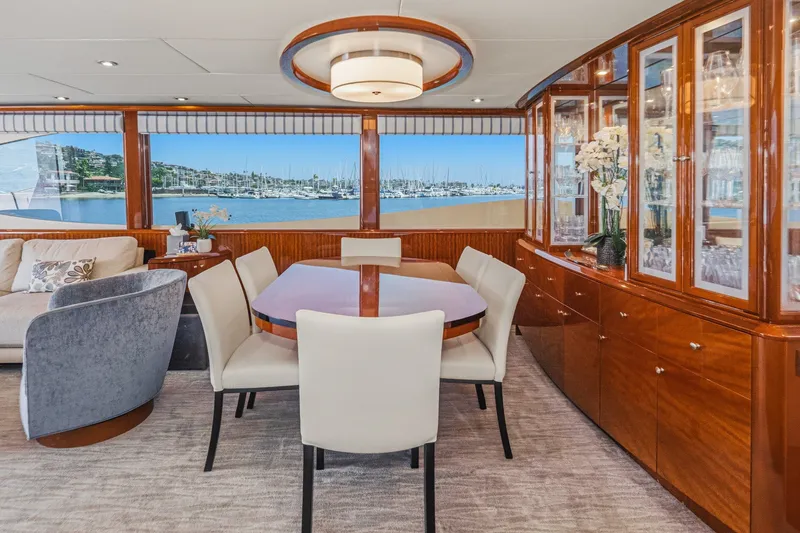 Slide: The Image of Luxurious interior of 2006 Lazzara 84 Flybridge yacht with elegant dining area and marina view. - 46