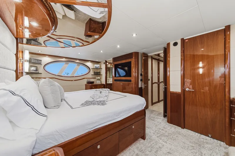 Slide: The Image of Luxurious 2006 Lazzara 84 Flybridge yacht bedroom with elegant wood finishes and modern decor. - 84
