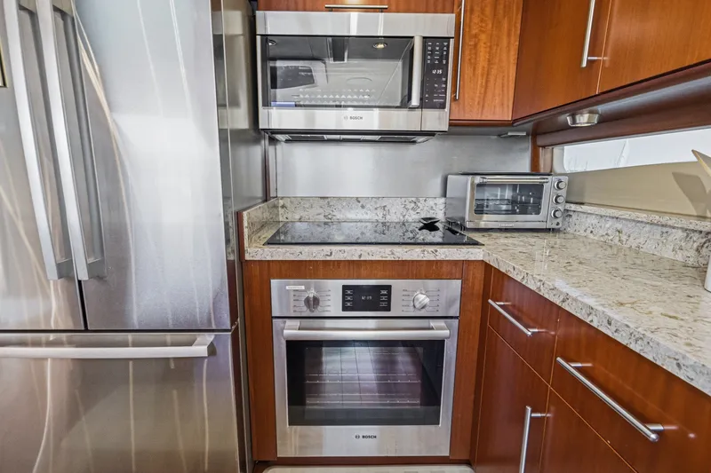 Slide: The Image of Modern kitchen in 2006 Lazzara 84 Flybridge yacht with stainless steel appliances. - 56