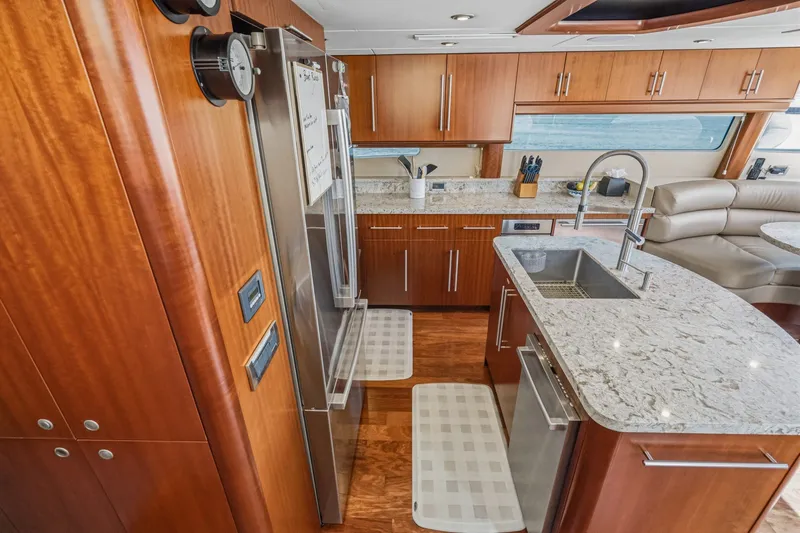 Slide: The Image of Luxurious kitchen interior of 2006 Lazzara 84 Flybridge yacht with modern appliances and wood cabinetry. - 48