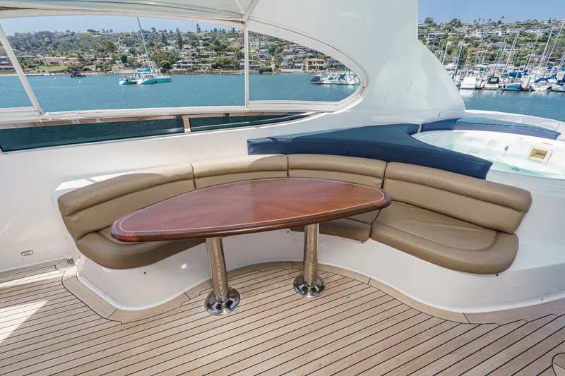 Slide: The Image of Luxurious 2006 Lazzara 84 Flybridge yacht with elegant seating and scenic marina view. - 31