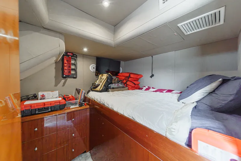 Slide: The Image of Cozy cabin interior of 2006 Lazzara 84 Flybridge yacht with bed and storage. - 94