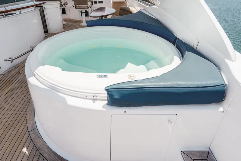 Slide: The Image of Luxurious hot tub on 2006 Lazzara 84 Flybridge yacht deck, featuring elegant wood flooring. - 36