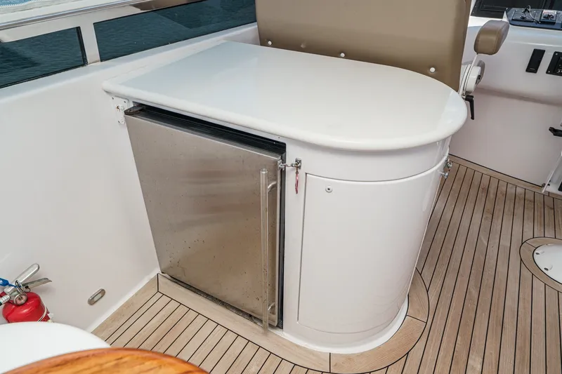 Slide: The Image of 2006 Lazzara 84 Flybridge yacht interior with compact fridge and sleek countertop. - 34