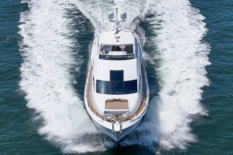 The Image of 2006 Lazzara 84 Flybridge yacht cruising on open water, aerial view. - 3