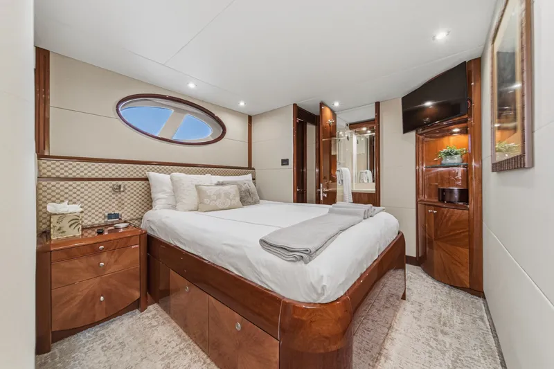 Slide: The Image of Luxurious bedroom interior of 2006 Lazzara 84 Flybridge yacht with elegant wood finishes. - 81