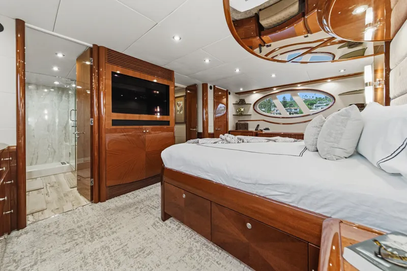 Slide: The Image of Luxurious bedroom interior of 2006 Lazzara 84 Flybridge yacht with elegant wood finishes. - 85
