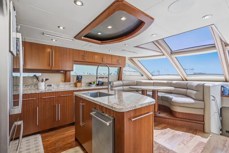 Slide: The Image of Luxurious interior of 2006 Lazzara 84 Flybridge yacht with modern kitchen and seating area. - 51