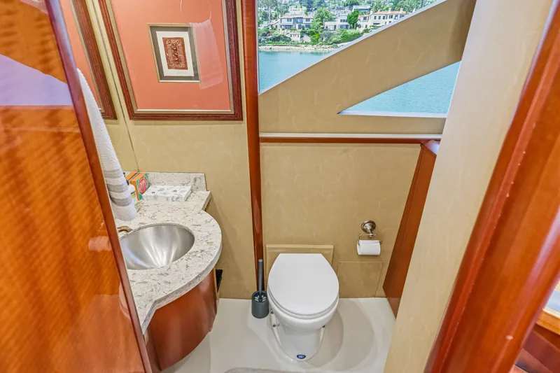 Slide: The Image of Luxurious bathroom on 2006 Lazzara 84 Flybridge yacht with modern fixtures and scenic window view. - 62