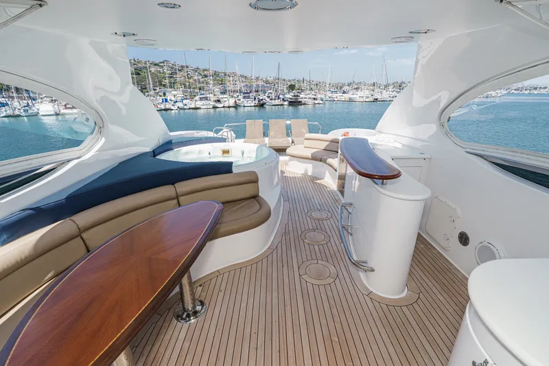 Slide: The Image of Luxurious 2006 Lazzara 84 Flybridge yacht with elegant seating and scenic marina view. - 32