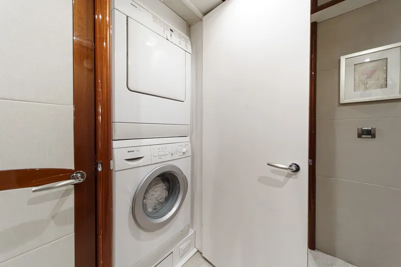 Slide: The Image of Laundry area with Bosch washer-dryer in 2006 Lazzara 84 Flybridge yacht. - 64