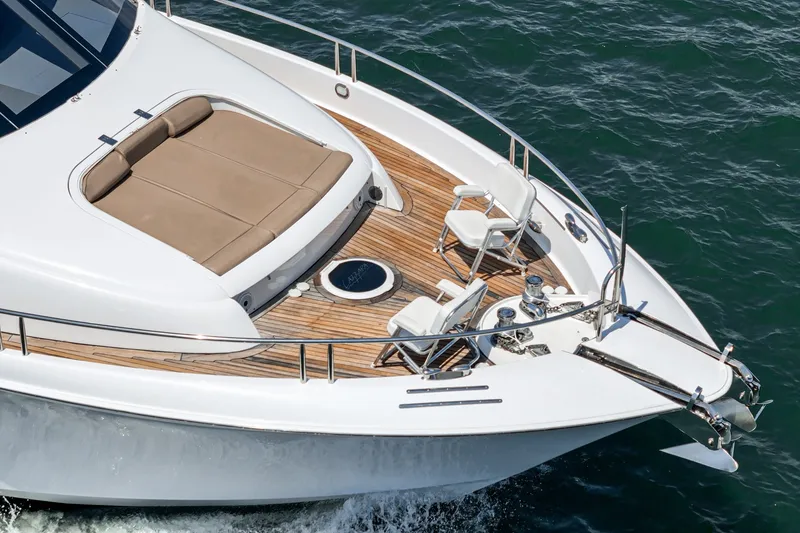 Slide: The Image of Luxury 2006 Lazzara 84 Flybridge yacht with spacious deck and seating area. - 16