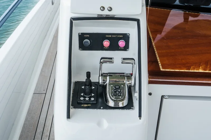 Slide: The Image of Control panel of a 2006 Lazzara 84 Flybridge yacht with joystick and switches. - 24