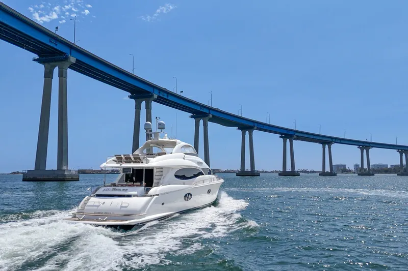 Slide: The Image of Luxury 2006 Lazzara 84 Flybridge yacht cruising under a scenic bridge. - 13
