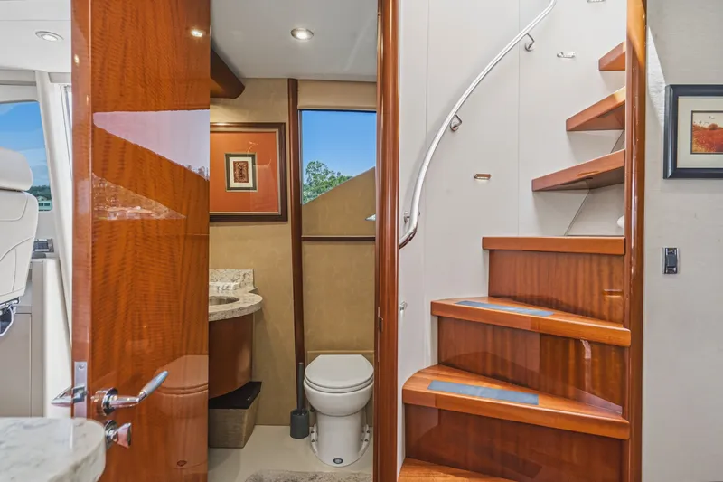 Slide: The Image of Luxurious 2006 Lazzara 84 Flybridge yacht interior with elegant wooden staircase and modern bathroom. - 61
