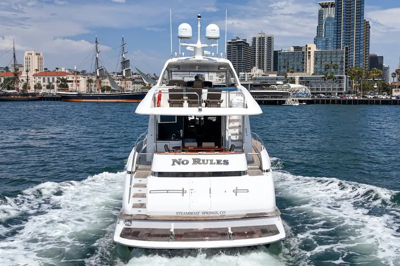 Slide: The Image of Luxury 2006 Lazzara 84 Flybridge yacht cruising near city skyline. - 93