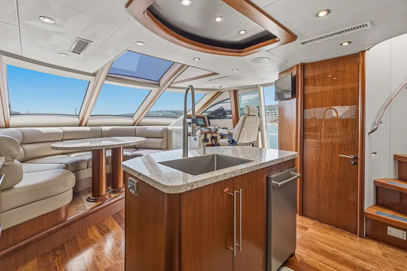 Slide: The Image of Luxurious interior of 2006 Lazzara 84 Flybridge yacht with modern kitchen and seating area. - 55