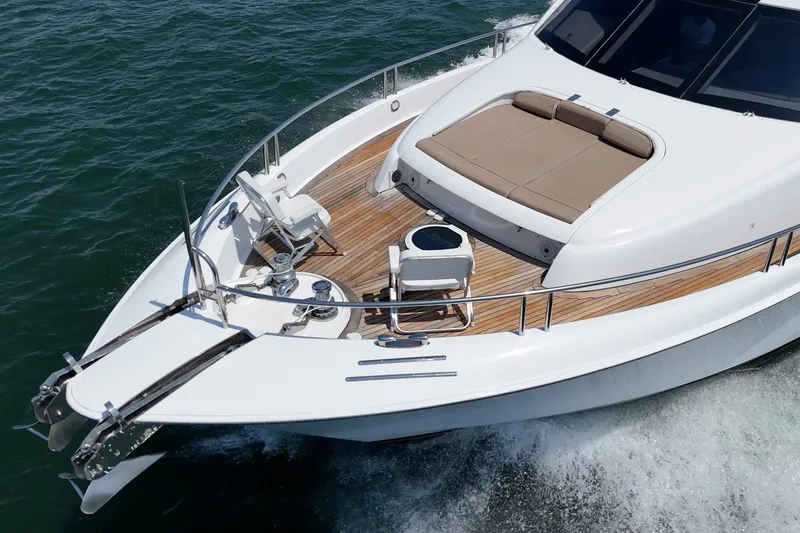 Slide: The Image of Luxury 2006 Lazzara 84 Flybridge yacht cruising on open water. - 15