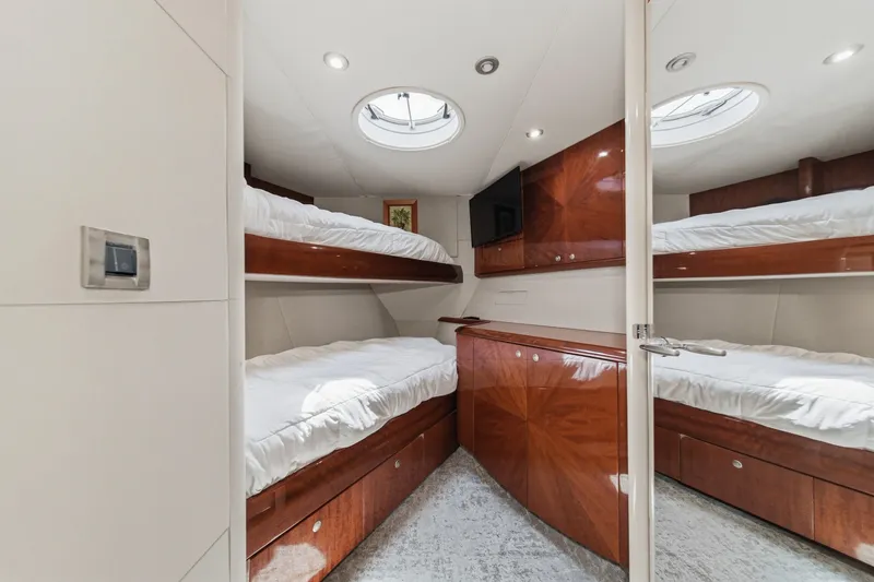 Slide: The Image of Luxurious 2006 Lazzara 84 Flybridge yacht cabin with elegant wood finishes and bunk beds. - 68