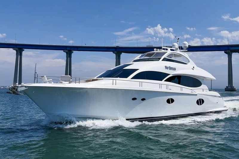 Slide: The Image of Luxury 2006 Lazzara 84 Flybridge yacht cruising under a blue sky near a bridge. - 11