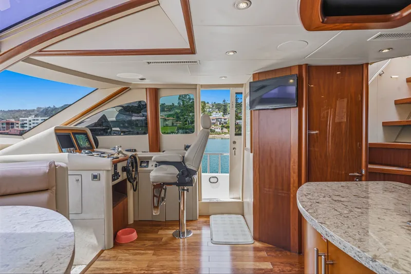 Slide: The Image of Luxurious interior of 2006 Lazzara 84 Flybridge yacht with modern helm and elegant wood finishes. - 58