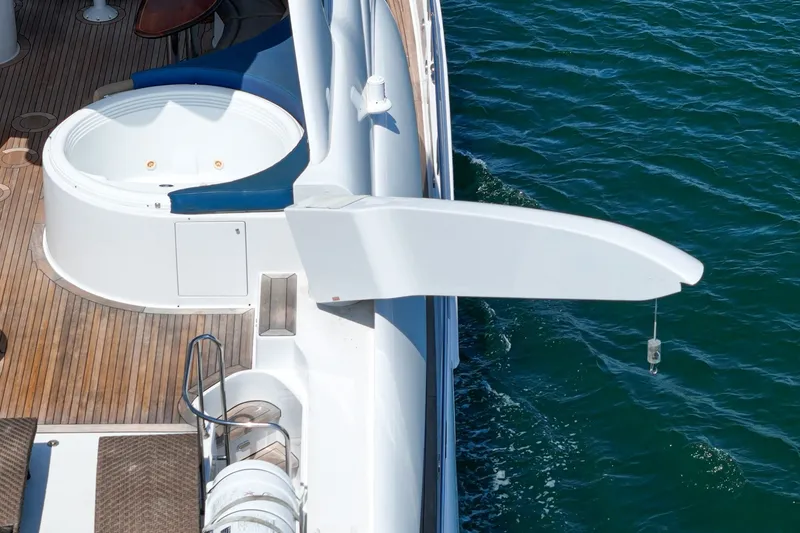 Slide: The Image of 2006 Lazzara 84 Flybridge yacht deck with jacuzzi and crane over water. - 38