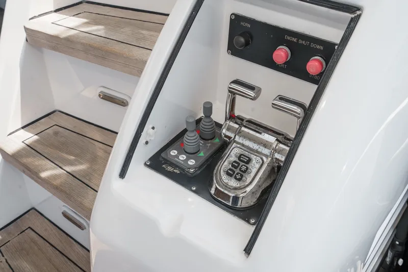 Slide: The Image of Control panel of 2006 Lazzara 84 Flybridge yacht with wooden steps in background. - 25