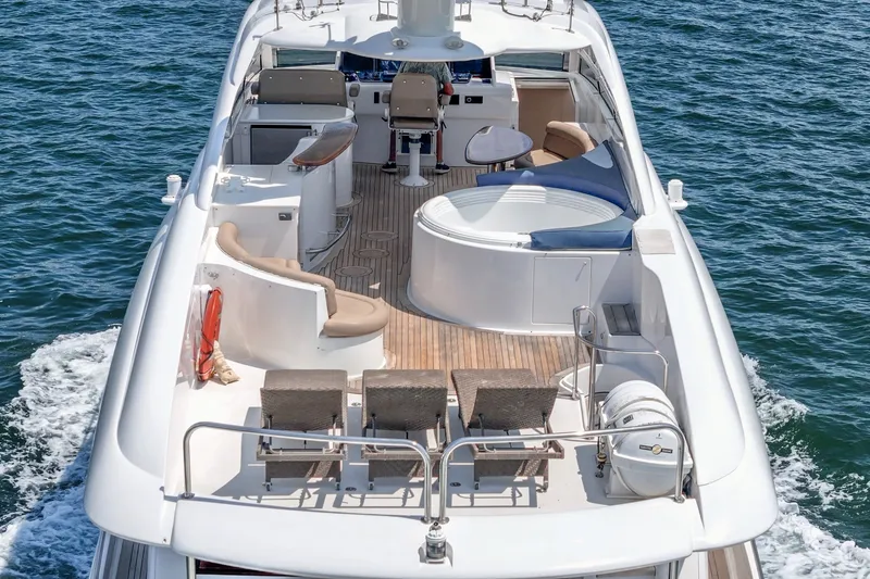 Slide: The Image of Luxurious 2006 Lazzara 84 Flybridge yacht with spacious deck and seating area on the water. - 26