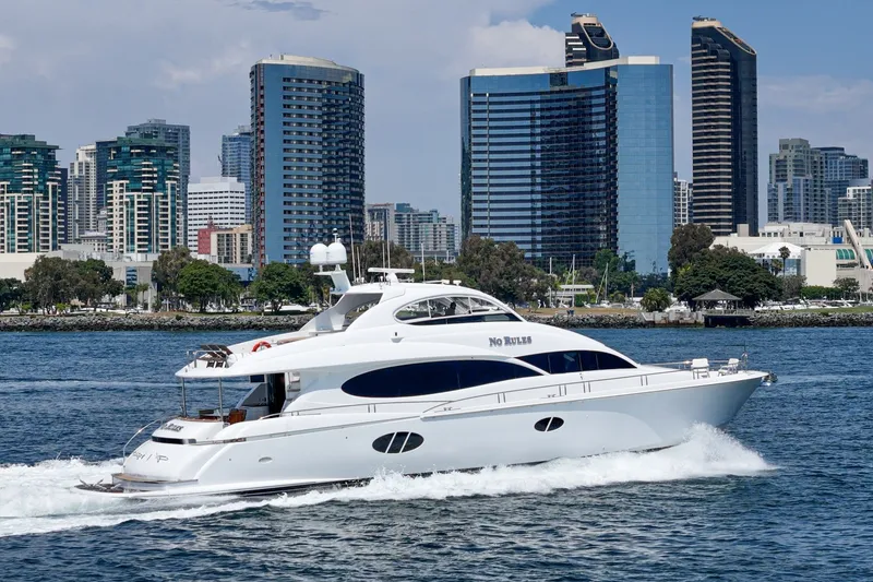 Slide: The Image of Luxury 2006 Lazzara 84 Flybridge yacht cruising near city skyline. - 8