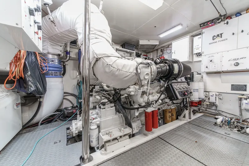 Slide: The Image of Engine room of a 2006 Lazzara 84 Flybridge yacht, featuring CAT Marine Power systems. - 103