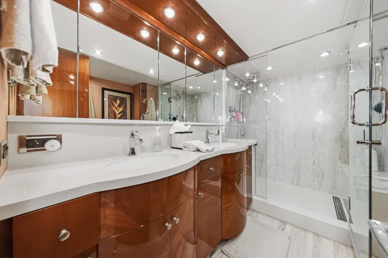 Slide: The Image of Luxurious bathroom on 2006 Lazzara 84 Flybridge yacht with elegant wood cabinetry and glass shower. - 91