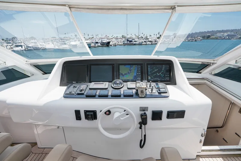 Slide: The Image of Helm of 2006 Lazzara 84 Flybridge yacht with navigation screens and controls. - 29
