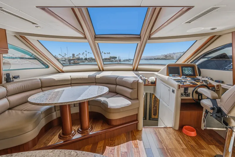 Slide: The Image of Luxurious interior of 2006 Lazzara 84 Flybridge yacht with panoramic windows and plush seating. - 54