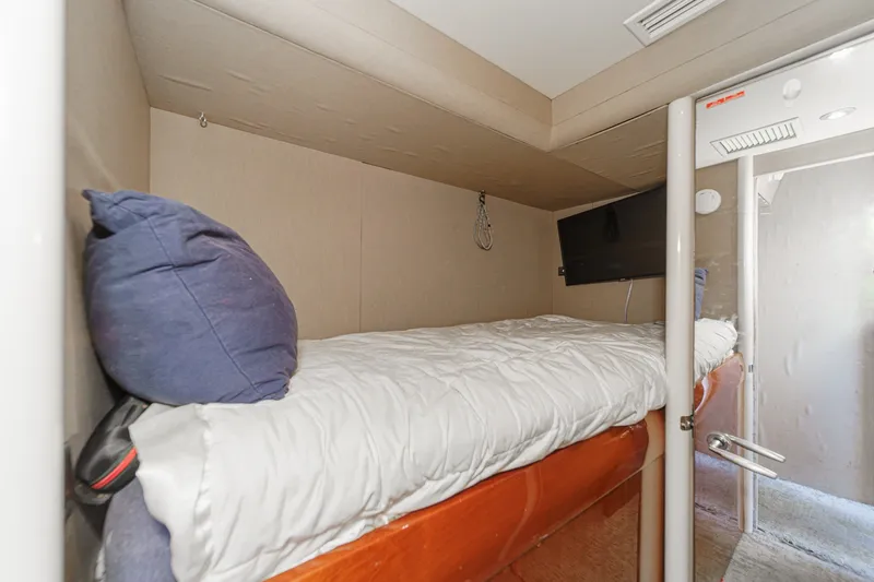 Slide: The Image of Cozy cabin interior of 2006 Lazzara 84 Flybridge yacht with bed and TV. - 95