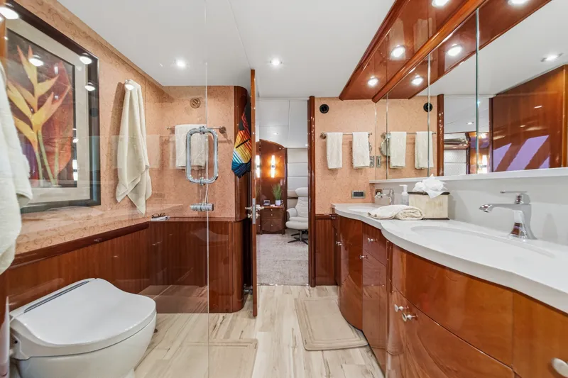 Slide: The Image of Luxurious bathroom in 2006 Lazzara 84 Flybridge yacht, featuring elegant wood finishes and modern fixtures. - 89