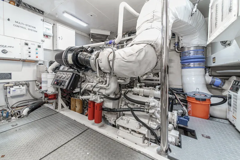 Slide: The Image of Engine room of 2006 Lazzara 84 Flybridge yacht, featuring advanced control systems and machinery. - 99
